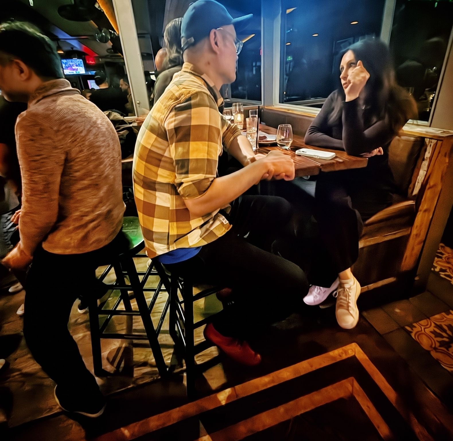 Two attendees deep in conversation at a window table